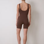 Stretchy bodysuit with no front seam or camel toe, bra-free design, and breathable moisture-wicking fabric, suitable for Pilates