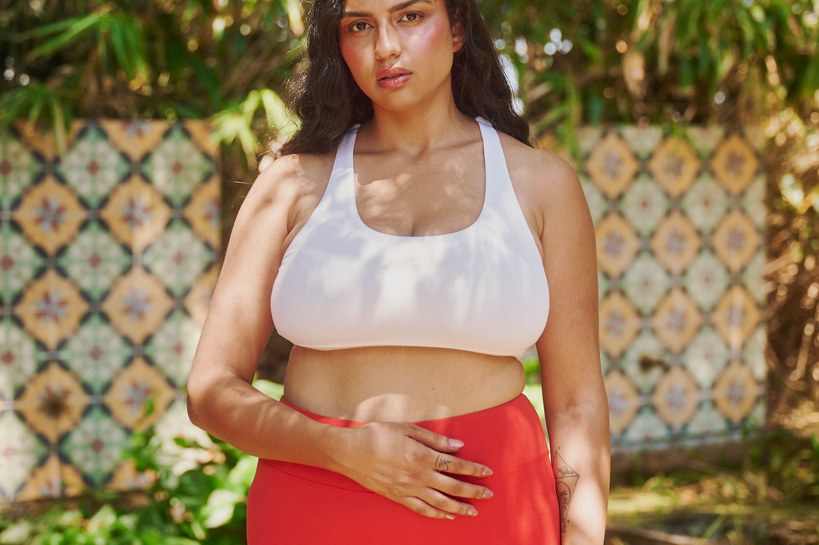 size-12-model-in-nature-wearing-estroni-merino-vanilla-white-racerback-sports-bra-and-estroni-merino-scarlet-red-shorts-5"