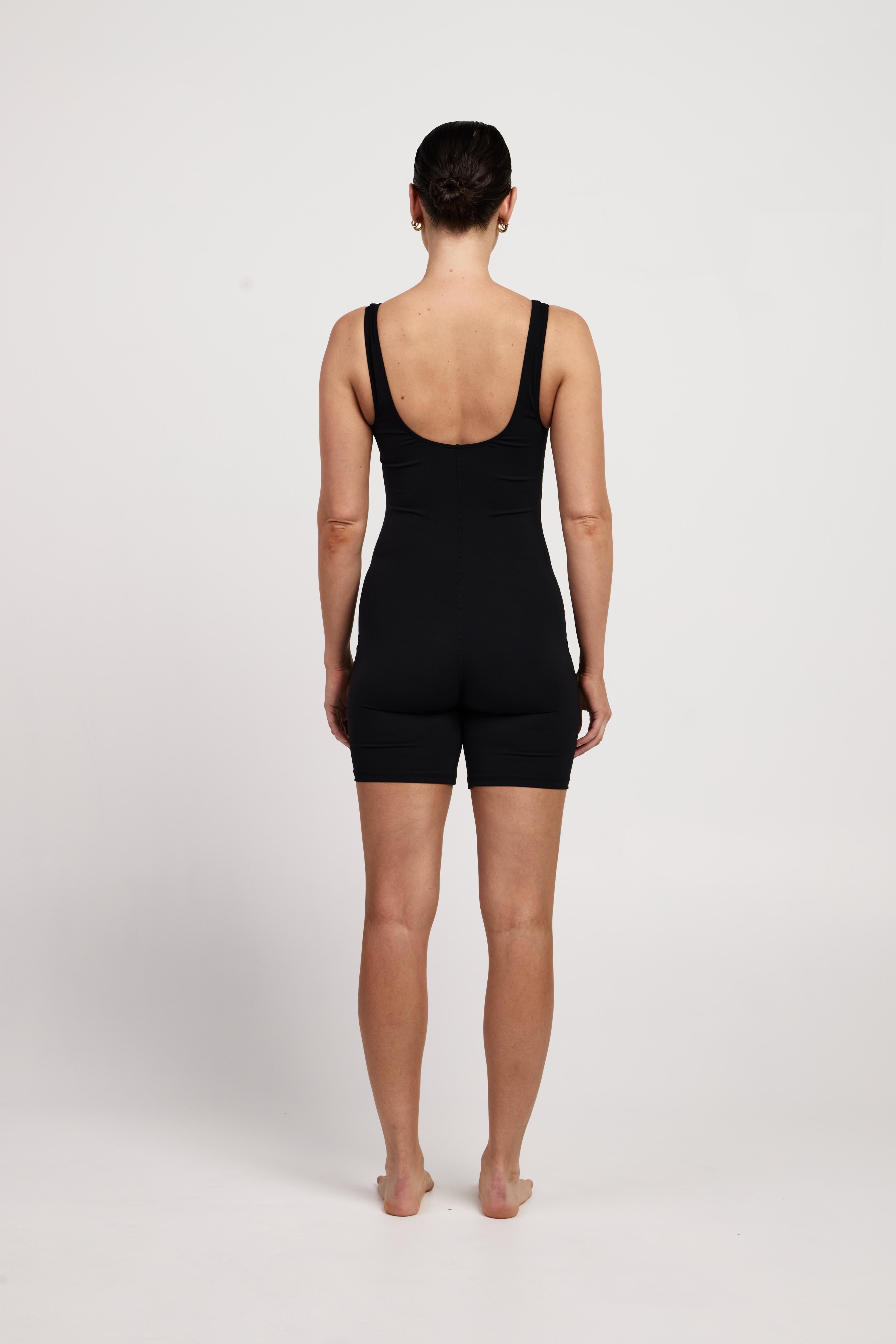 Bra-free activewear bodysuit with 6-inch shorts, stretchy fabric, moisture-wicking design, and a classic fit, suitable for Pilates