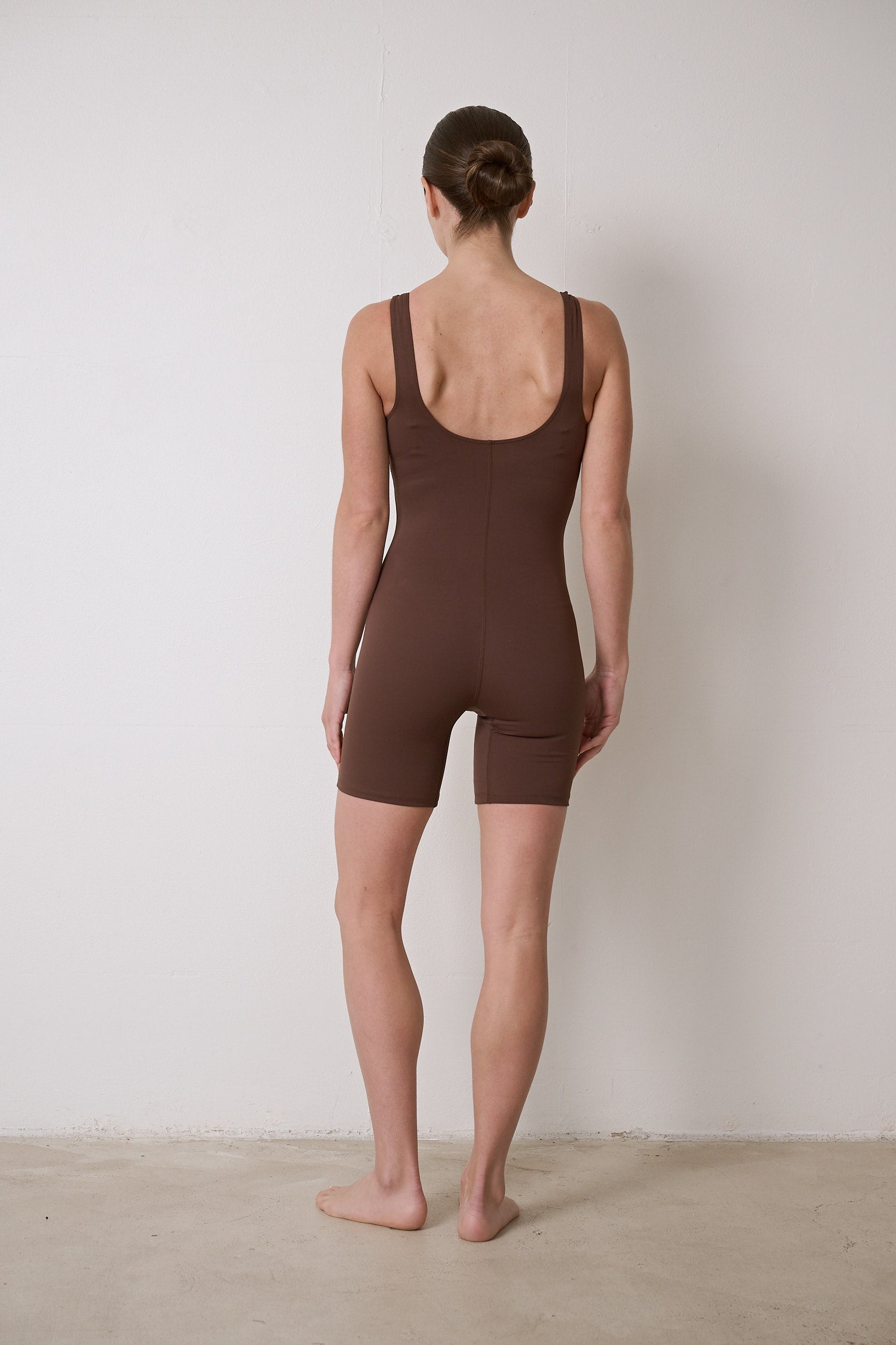 Stretchy bodysuit with no front seam or camel toe, bra-free design, and breathable moisture-wicking fabric, suitable for Pilates