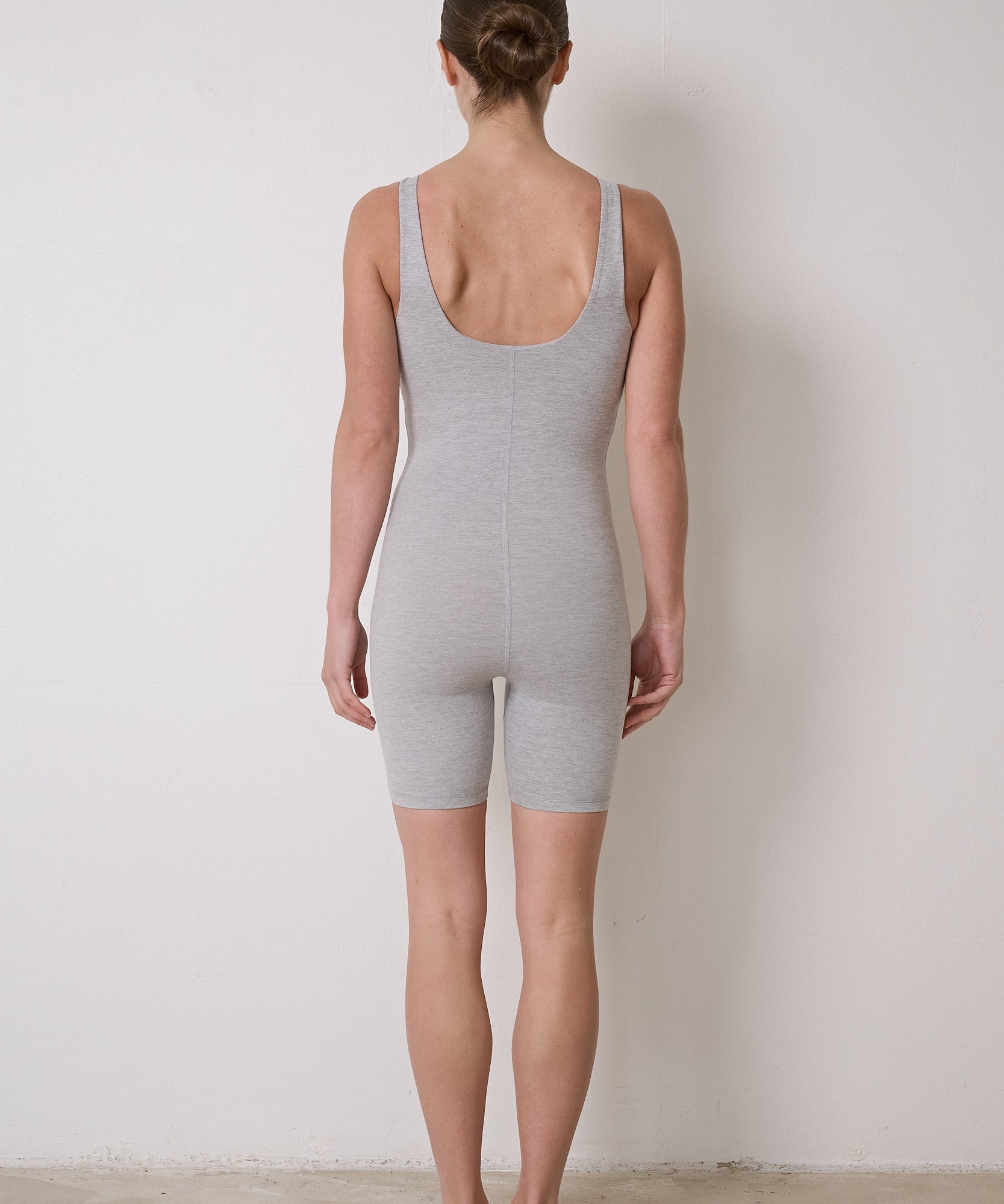 Flattering women's bodysuit featuring an in-built bra, stretchy material, and 6-inch short legs, ideal for Pilates