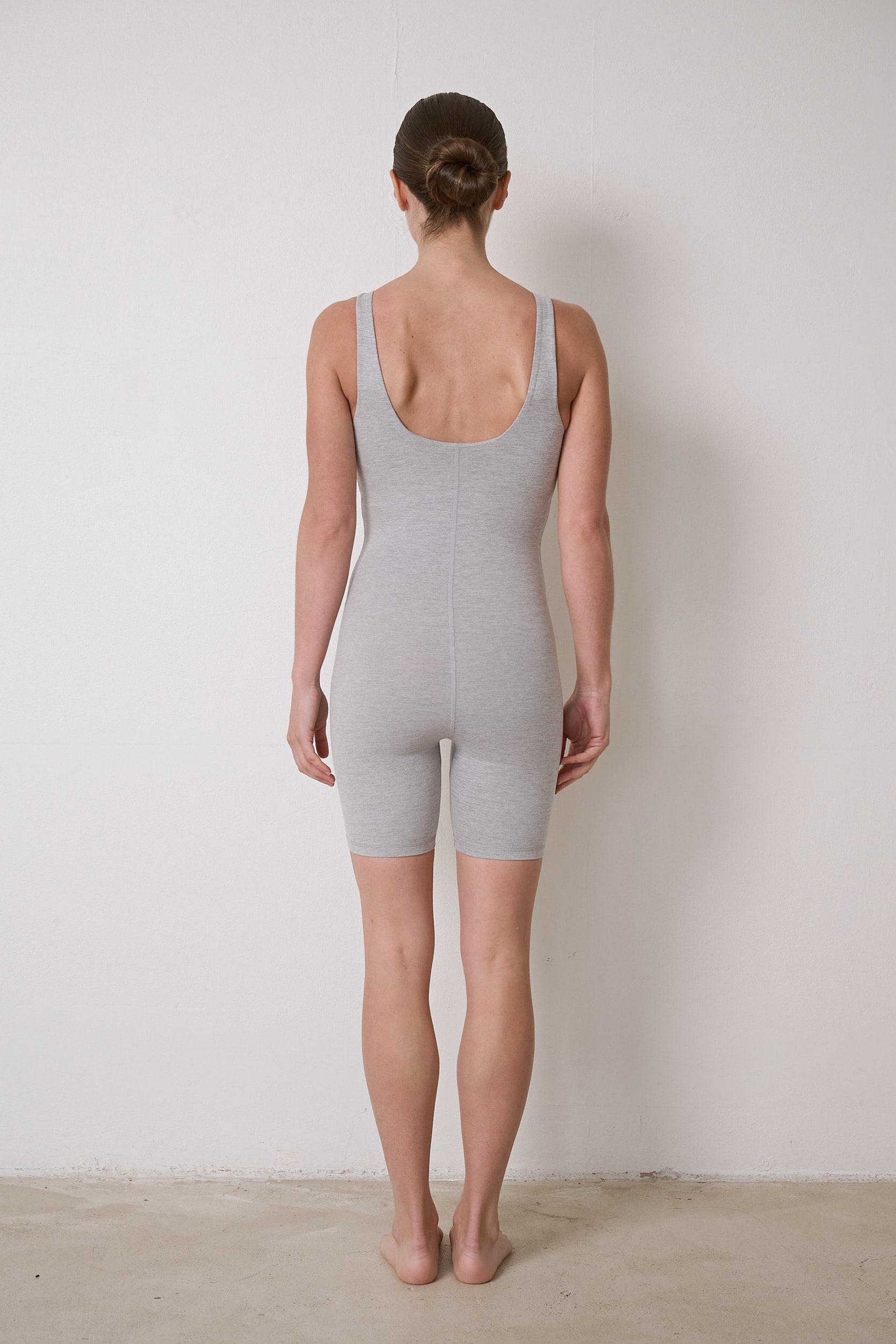 Flattering women's bodysuit featuring an in-built bra, stretchy material, and 6-inch short legs, ideal for Pilates