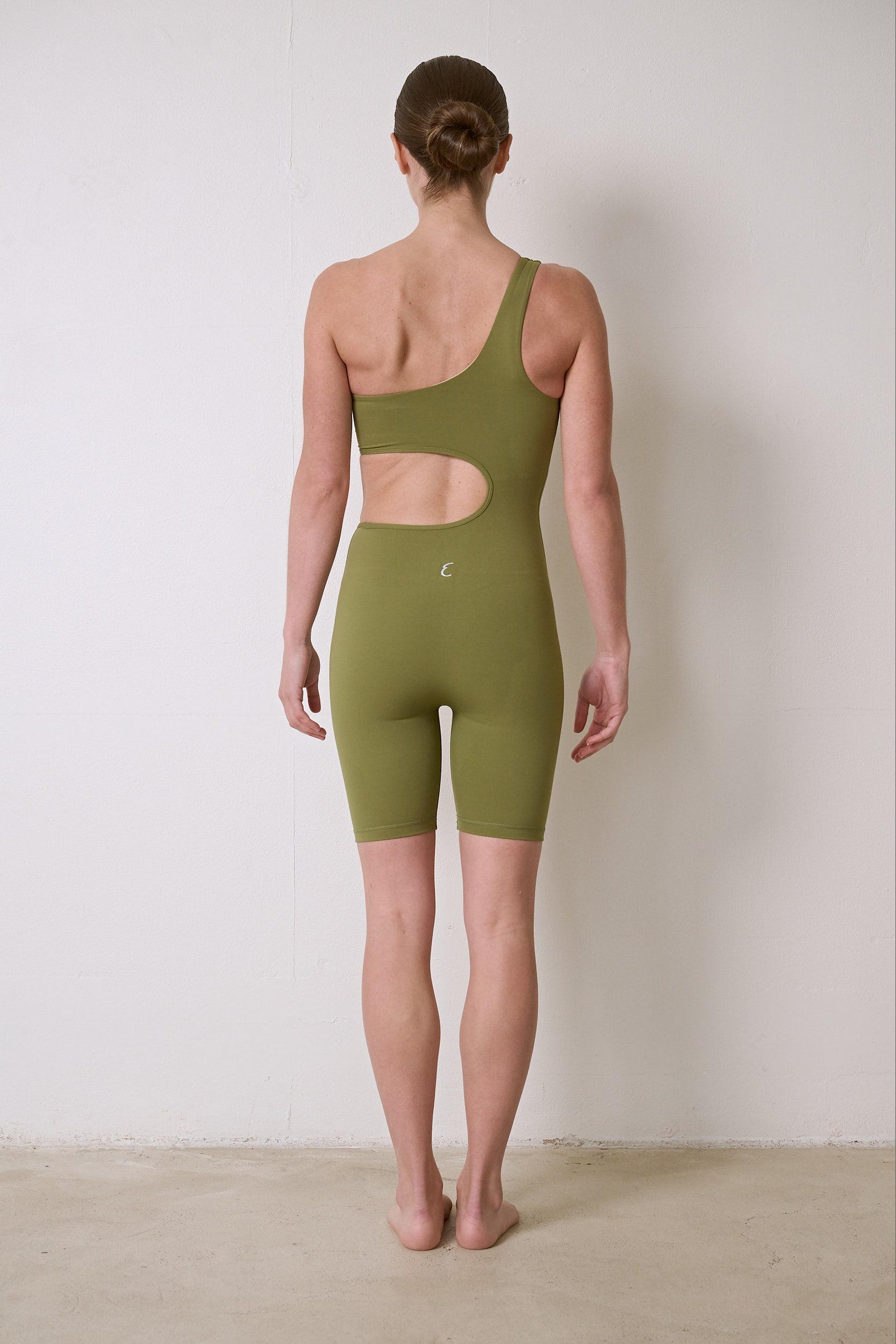 Flattering activewear bodysuit with a secure fit, moisture-wicking and breathable fabric, featuring a waist cutout for extra style