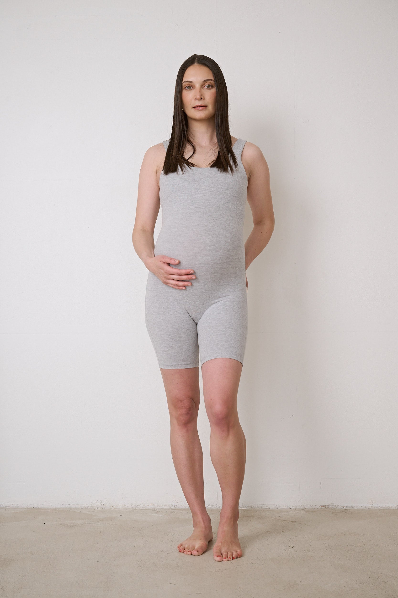 Bra-free activewear bodysuit with 6-inch short legs, featuring stretchy fabric, suitable for maternity