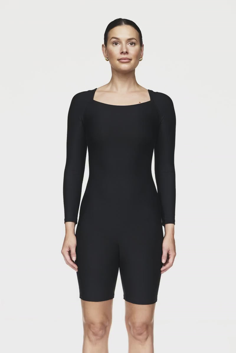 Breathable long-sleeve activewear bodysuit with short legs, designed for big busts, offering a flattering bra-free fit, ideal for Pilates workouts