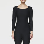 Breathable long-sleeve activewear bodysuit with short legs, designed for big busts, offering a flattering bra-free fit, ideal for Pilates workouts