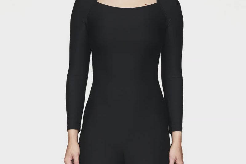 Breathable long-sleeve activewear bodysuit with short legs, designed for big busts, offering a flattering bra-free fit, ideal for Pilates workouts